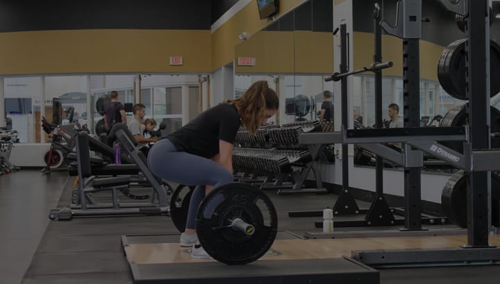 A woman who is doing deadlift in the gym